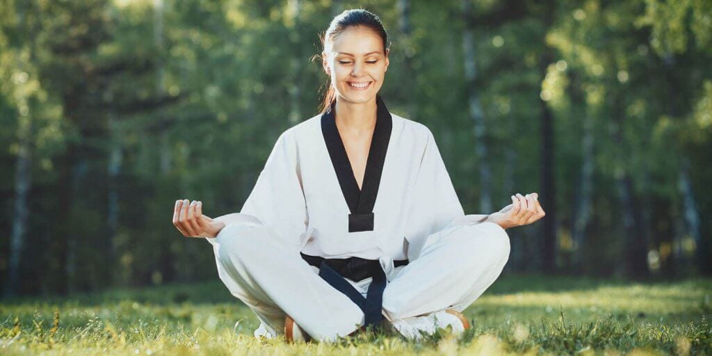 Martial Arts Lessons for Adults in Wauconda IL - Happy Woman Meditated Sitting Background